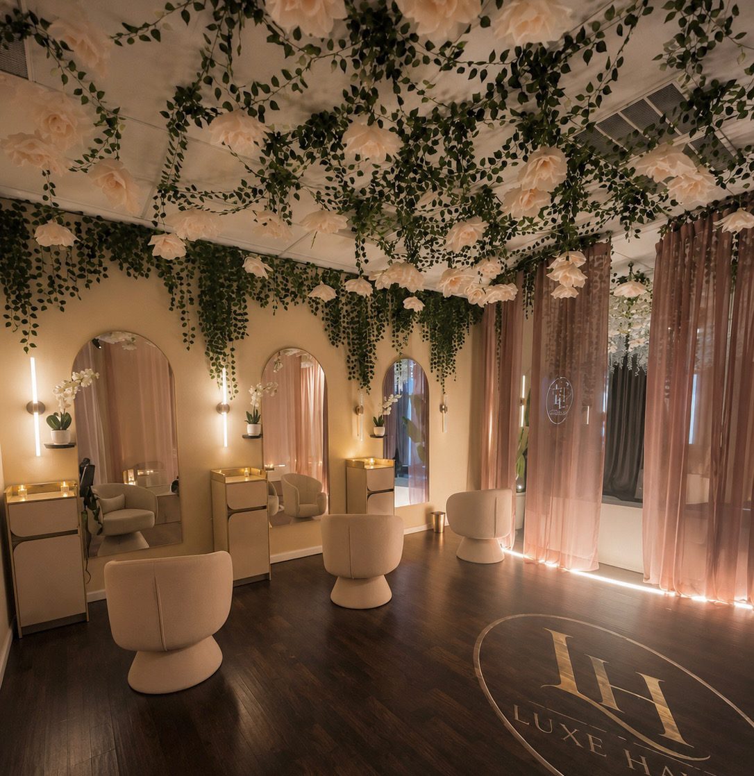 The styling room, with arched mirrors and gold-lit vanity stations